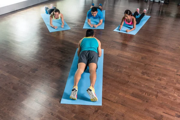 Vista de ángulo alto de un instructor de fitness durante la clase de calistenia de grupo — Foto de Stock