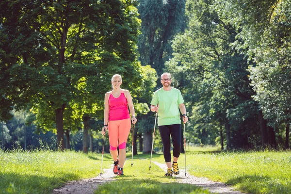 Couple doing Nordic Walking for sport — Stock Photo, Image