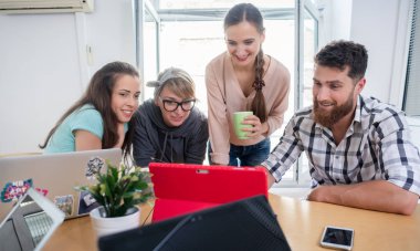 Modern bir paylaşılan Office iş sunum izlerken dört ortak çalışanlar