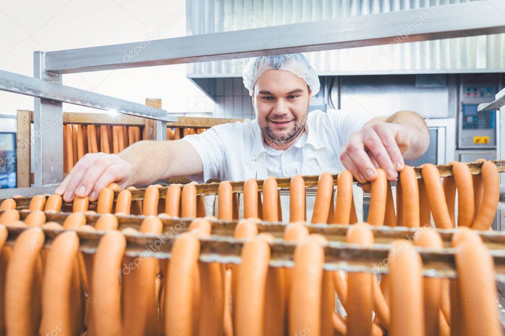 Butcher man making sausages ready to be smoked