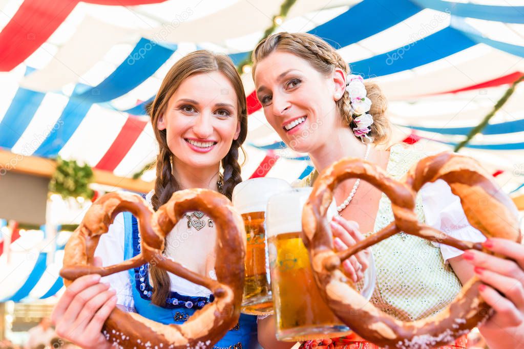 Friends at Bavarian Fair with giant pretzels