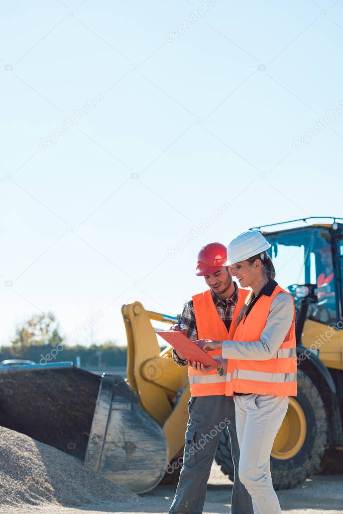 Man and woman worker on construction site