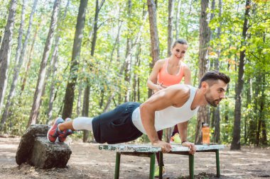 Push-up açık bir spor salonunda yapan sportif erkek