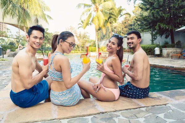 Retrato de grupo de cuatro jóvenes y hermosas personas bebiendo cócteles — Foto de Stock