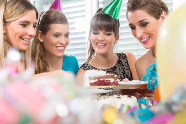 Quatro mulheres bonitas e melhores amigos sorrindo enquanto compartilham um bolo de aniversário — Fotografia de Stock