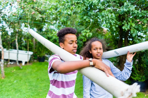 Close Brother Sister Carrying Pole Shoulder Park — Stock Photo, Image