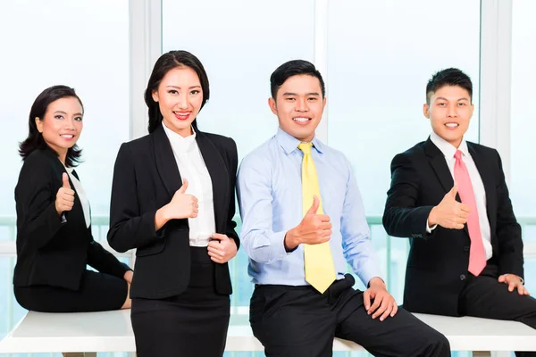 Businesspeople showing thumbsup sign — Stock Photo, Image