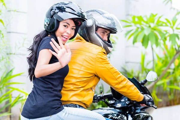 Girlfriend riding with boyfriend on motorbike — Stock Photo, Image