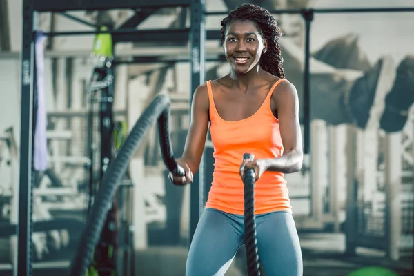 Strong woman exercising with battle ropes during functional training — Stock Photo, Image