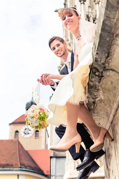 Married couple holding flower bouquet