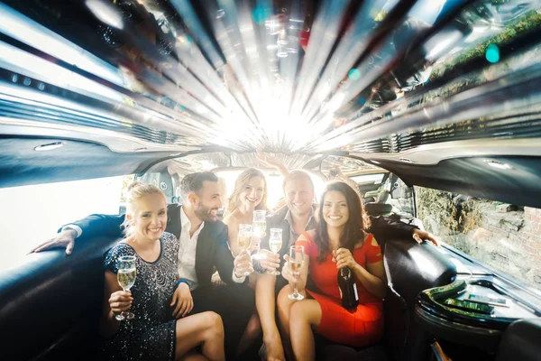 Feier in der Limousine, Frau und Männer trinken Champagner — Stockfoto