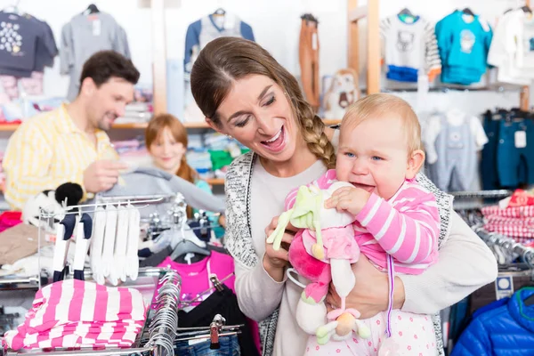 Kvinna som bär hennes baby i butik — Stockfoto