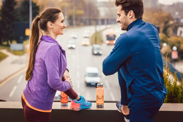 Athletic couple exercising for better fitness in the city