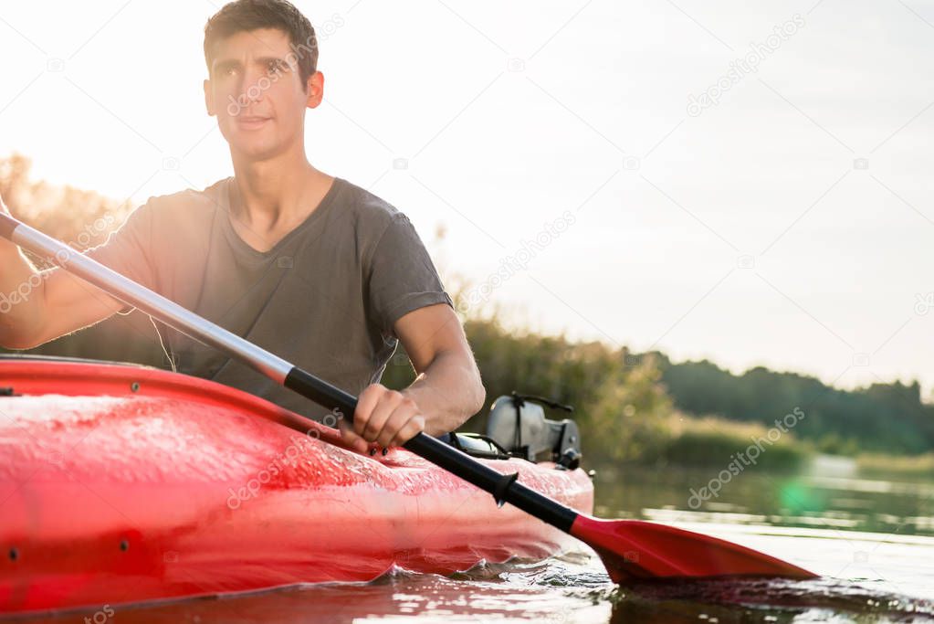 Man kayaking using paddle