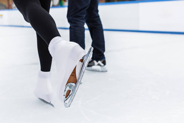 Close-up of skaters on ice rink