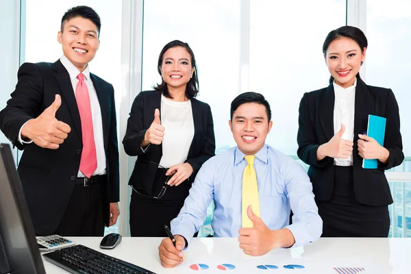 Successful businesspeople showing thumbs up sign — Stock Photo, Image