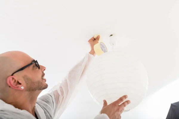 Masculino decorador fixação o fita no teto — Fotografia de Stock