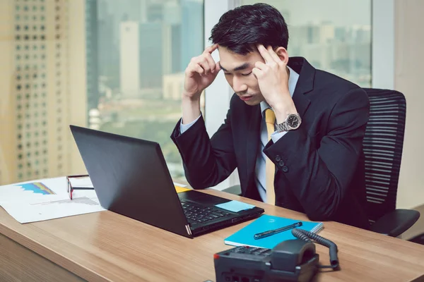 Stress young businessman at workplace — Stock Photo, Image