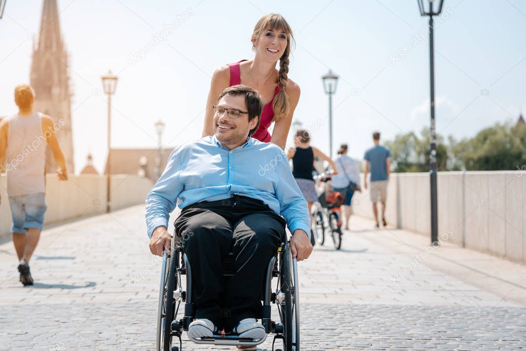 Woman and her friend in a wheelchair having stroll through the t