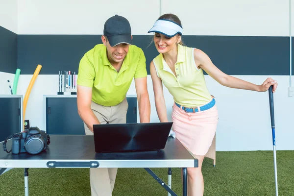 Cheerful woman watching her video recorded strike during a golf class — Stock Photo, Image