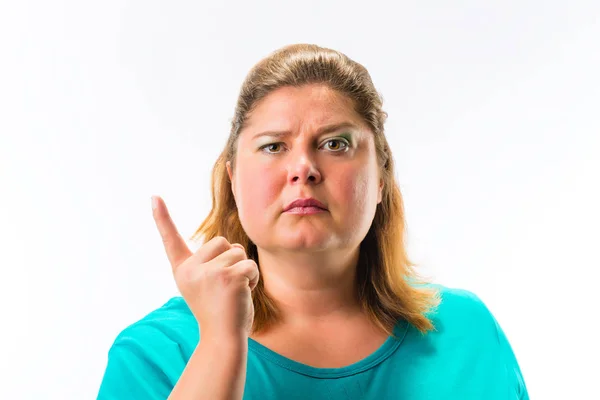 Seriös kvinna som pekar fingret uppåt — Stockfoto