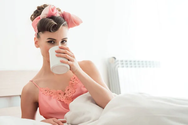 Mulher bonita bebendo seu café da manhã ainda na cama — Fotografia de Stock