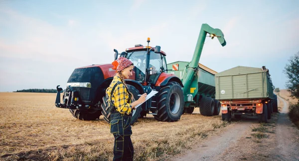 Farmer crunching numbers of field after a long harvest day — Stock Photo, Image
