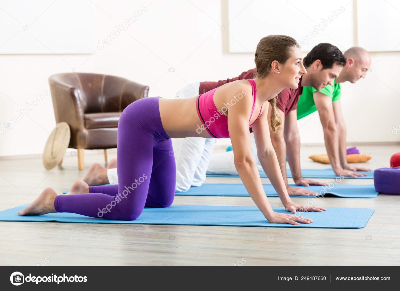 three people stretching on yoga mats Stock Photo - Alamy