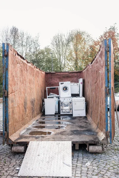 Old electrical appliances in container of recycling center