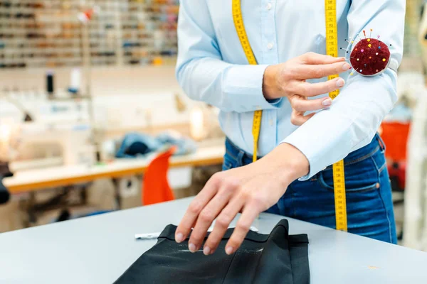 Alterations tailor working on some trousers — Stock Photo, Image