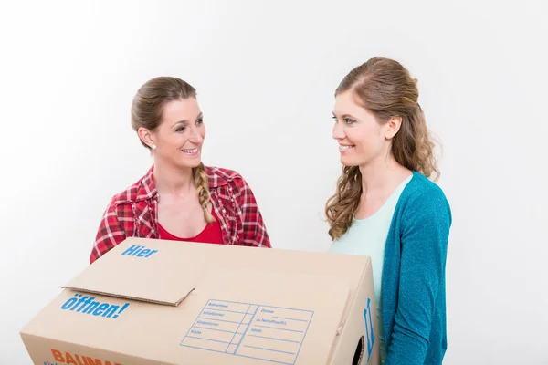 Smiling women carrying the cardboard box — Stock Photo, Image