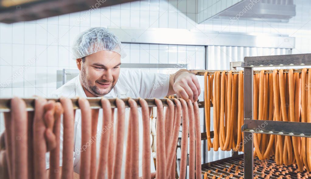 Butcher man making sausages ready to be smoked