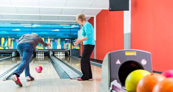 Rear view of a mature man bowling — Stock Photo, Image