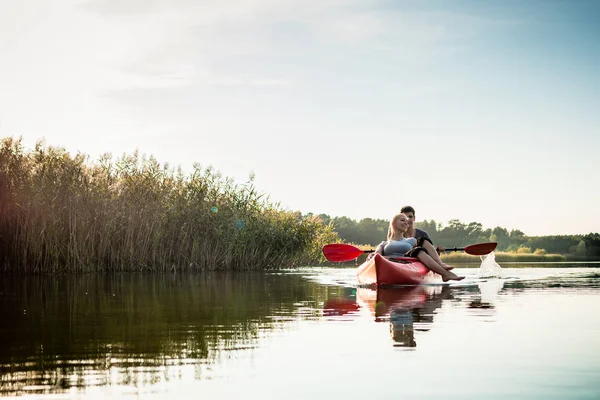 Woman relaxing in kayak with her boyfriend — ストック写真