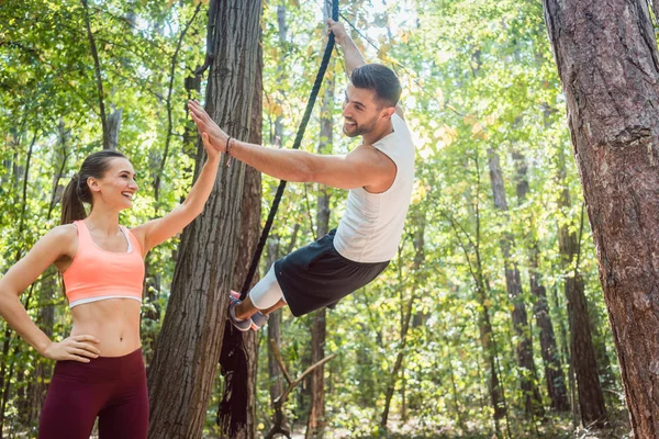 Woman and man giving high five while doing fitness sport — Stock Photo, Image