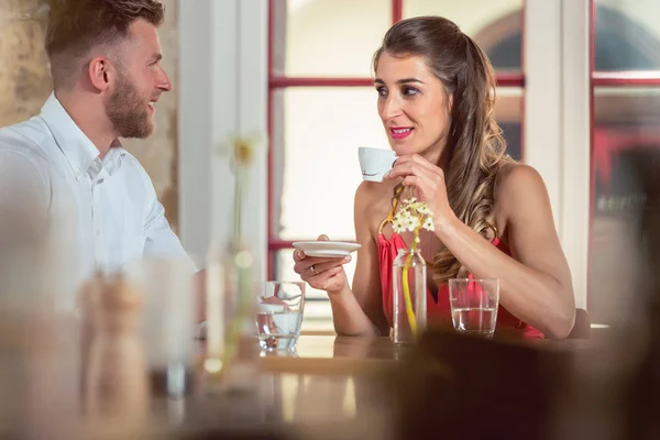 Woman holding cup looking at her boyfriend — Stockfoto