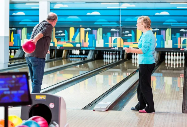 Rear view of a mature man bowling — Stock Photo, Image