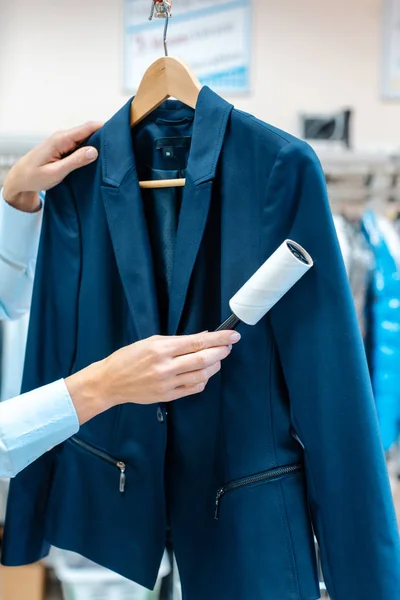 Wanita di toko dry cleaning menggunakan mesin penghancur untuk membersihkan jaket — Stok Foto