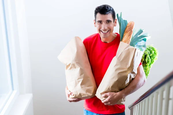 Delivery man delivering groceries