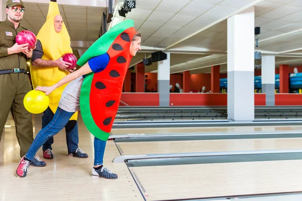 Woman in fancy clothing bowling — Stock Photo, Image