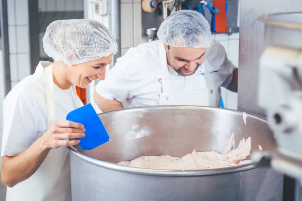 Boucher homme et femme travaillant ensemble hacher de la viande — Photo