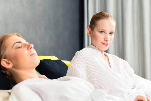 Woman in bathrobe relaxing in spa