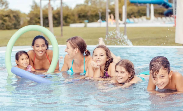 Happy family enjoying in swimming pool — Stock Photo, Image