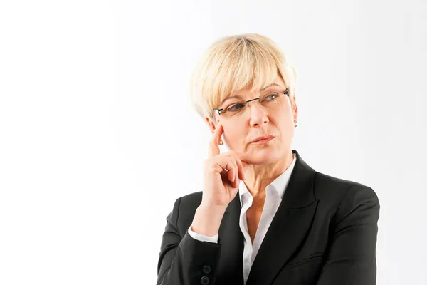 Contemplated mature businesswoman — Stock Photo, Image