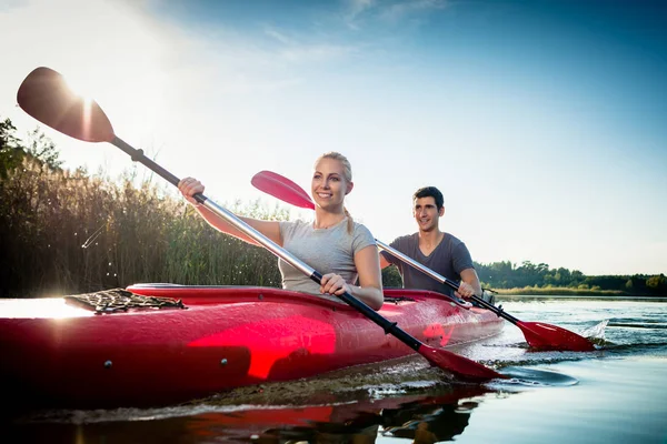 Couple paddling in kayak — Stock Photo, Image