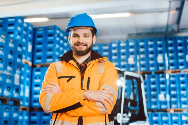 Trabalhador em uma empresa de encaminhamento com sua empilhadeira — Fotografia de Stock