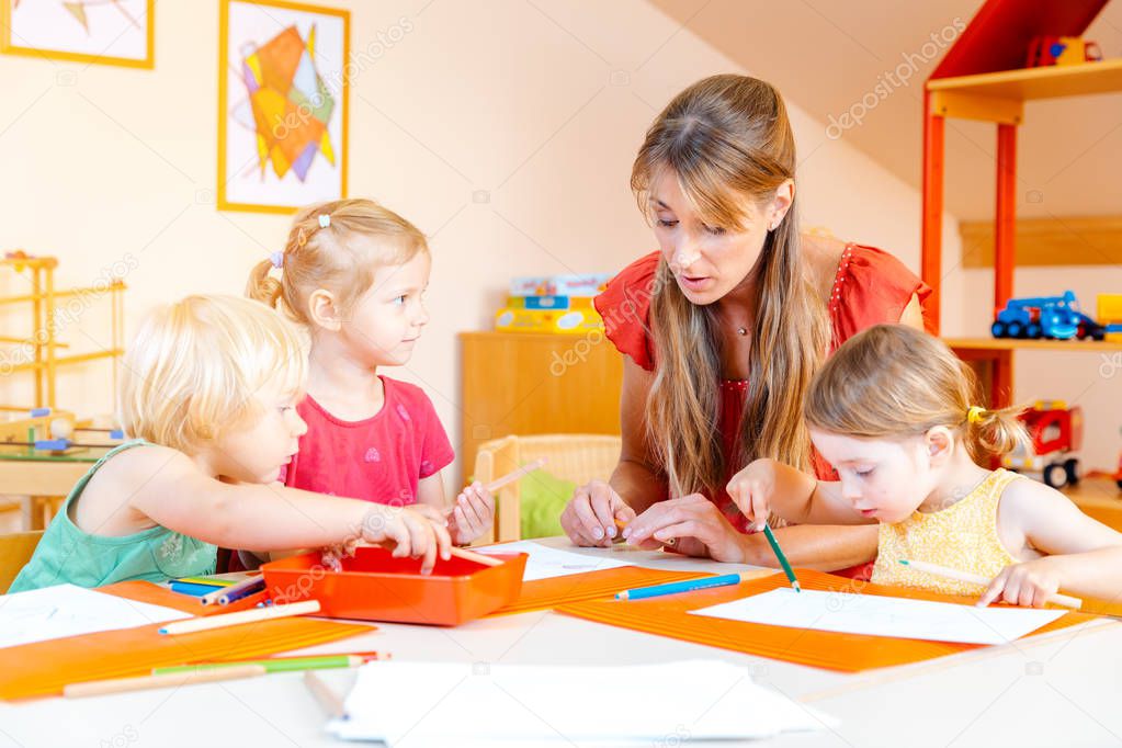 Children drawing in playgroup of nursery school