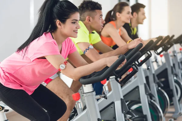 Athletic people cycling in row — Stock Photo, Image