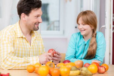 Babası kızı için bıçak ile elma kesme