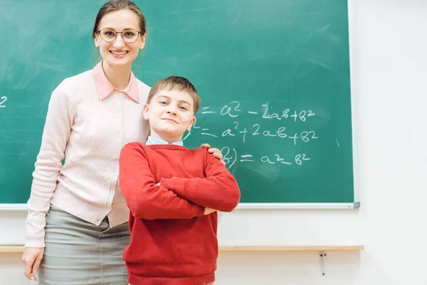Brilliant schoolboy is proud of his work and so is the teacher — Stock Photo, Image